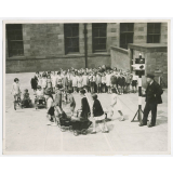 Scotland. Assisting Hore-Belisha. The children at the Hyndland Secondary School, Glasgow, are being taught road safety. A system of traffic signals has been erected in the school playground and kiddies with toy motor cars and tricyles represent the traffic while the others are taught how to cross the road with safety. Photo shows- Children being taught road safety, showing the model traffic lights used. Fox June 22nd. 36.