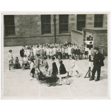 Scotland. Assisting Hore-Belisha. The children at the Hyndland Secondary School, Glasgow, are being taught road safety. A system of traffic signals has been erected in the school playground and kiddies with toy motor cars and tricyles represent the traffic while the others are taught how to cross the road with safety. Photo shows- Children being taught road safety, showing the model traffic lights used. Fox June 22nd. 36.