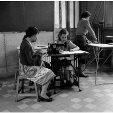 Ecole primaire de la Seine : deux enfants jouent aux cowboys dans la rue, devant des panneaux d'affichage (Poujade...).