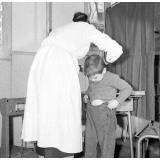 Visite médicale (cabinet mobile) à l'école primaire de Labruguière. Une infirmière aide un élève à se rhabiller.