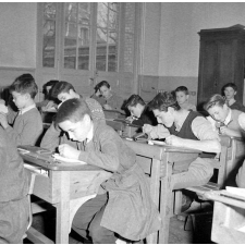 I.P.N. : scène de classe, des élèves penchés sur leurs pupitres