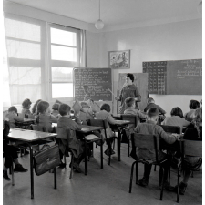 Ecole primaire. L'institutrice vérifie l'écriture sur les ardoises.